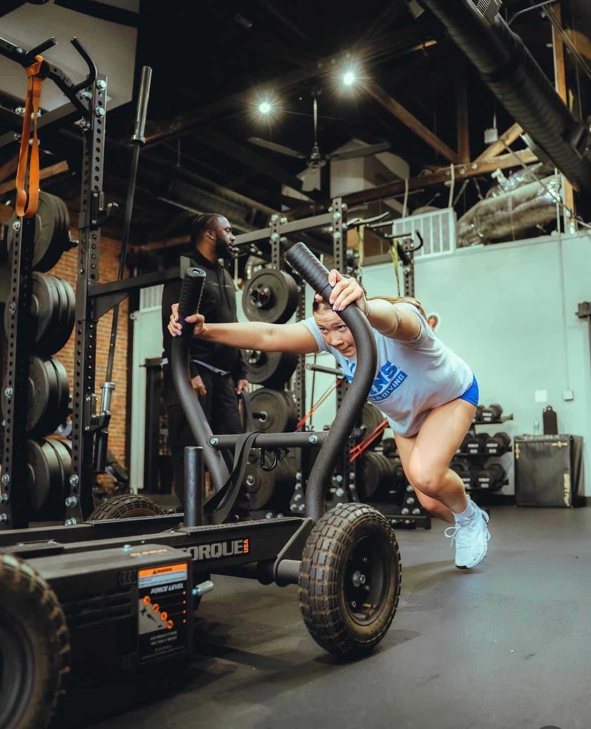 Athlete performing heavy sled push with coaching at G6 Performance Sacramento